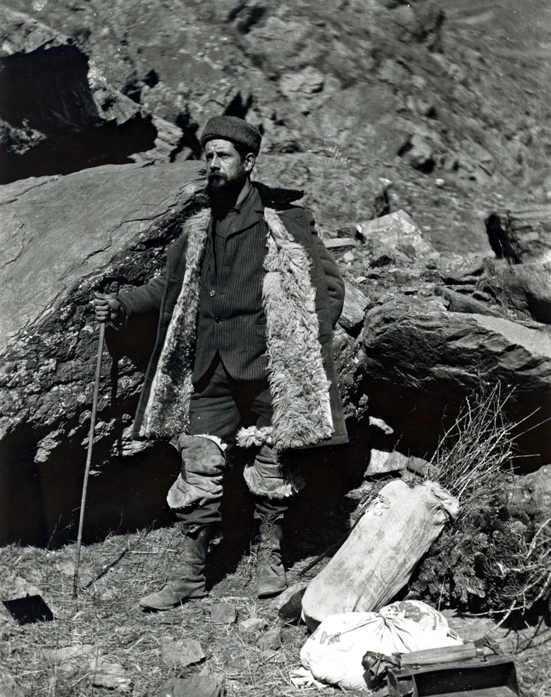 Meyer standing on mountainous terrain, dressed in winter gear and holding a walking stick.