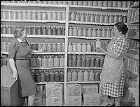 New Mexico. Mrs. Fidel Romero proudly exhibits her canned food.gif