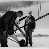 Edward F. Knipling in background of airplane