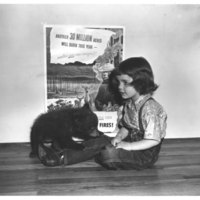 Judy Bell, 4 year old daughter of Ray Bell, New Mexico State Forester with her young friend, Smokey 