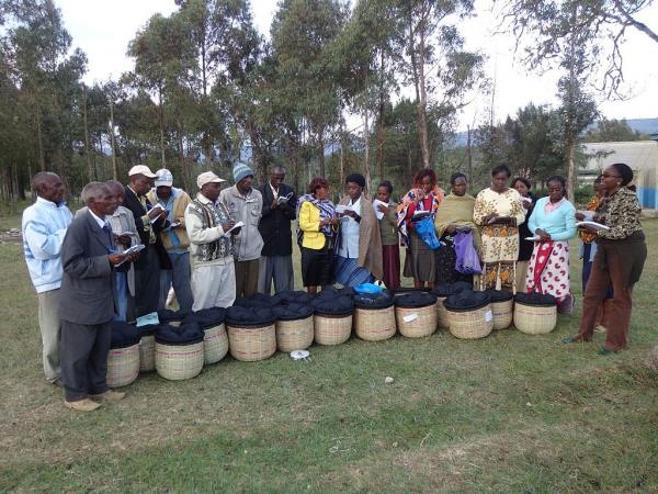 A Community Group Displaying Finalized Fire-Less Cooker Bucket They Made During a Training on How to Make Them