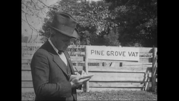 image of man standing in front of sign reading Pine Grove Vat